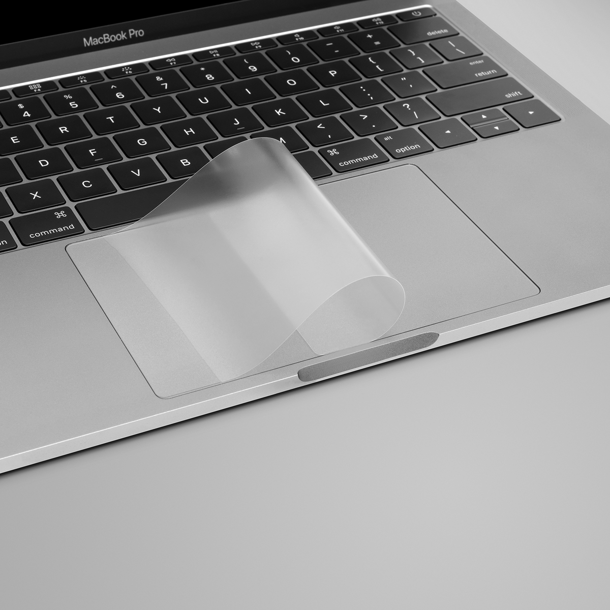 GhostCover Touch trackpad protector being applied to a MacBook Pro trackpad