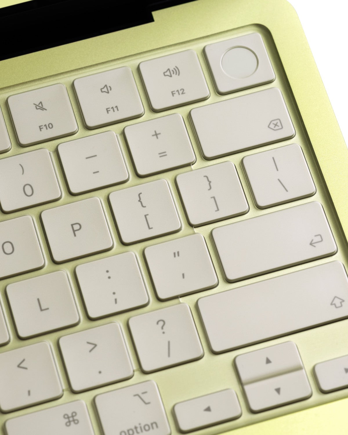Close-up of a clear GhostCover FlexType keyboard protector on a Citrus MacBook Neo keyboard with touch ID