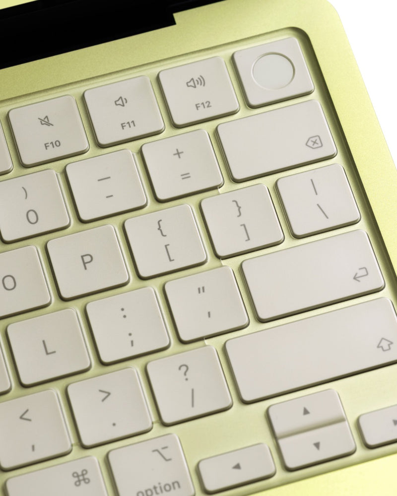 Close-up of a clear GhostCover FlexType keyboard protector on a Citrus MacBook Neo keyboard with touch ID