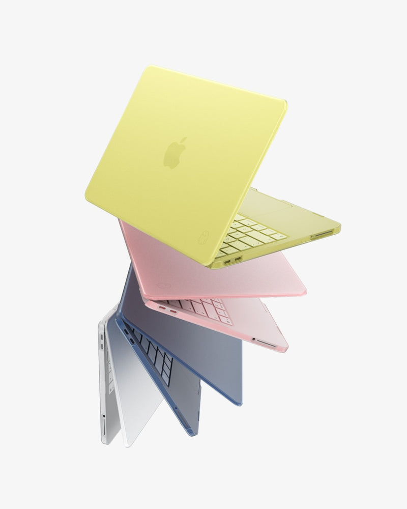 Four MacBook Neo laptops fanned open in Citrus, Blush, Indigo and Clear GhostShell Frost cases