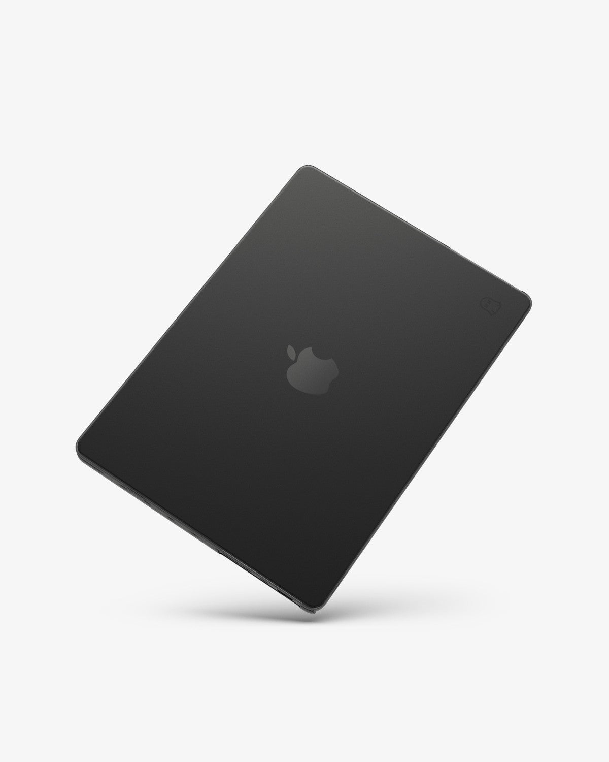 A space black MacBook Pro in a translucent black GhostShell Frost hardshell case, closed