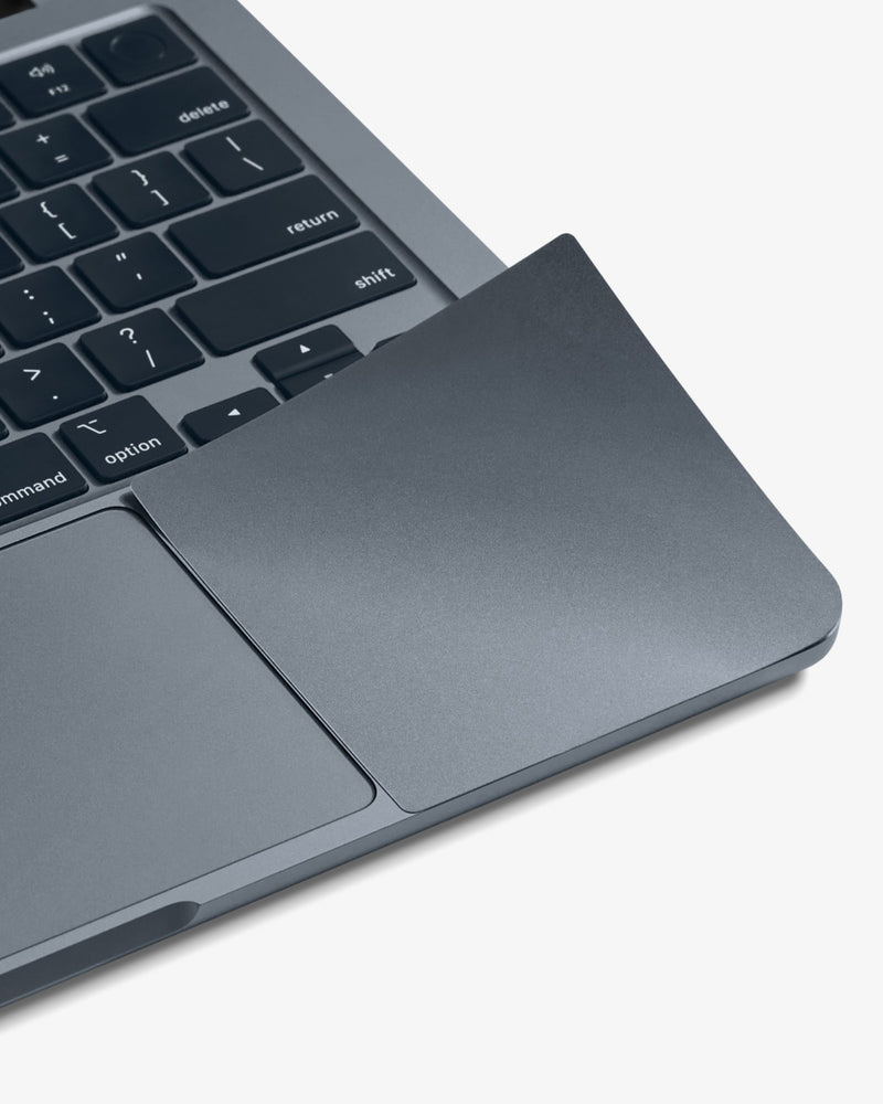 Close-up of a color-matched GhostShield palm rest protector on a Midnight MacBook Air.