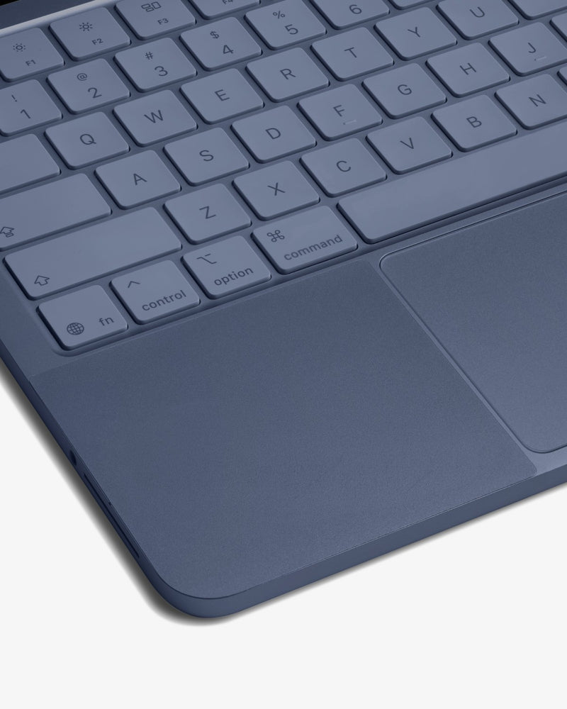 Close-up of GhostShield palm rest protector on an Indigo MacBook Neo keyboard deck