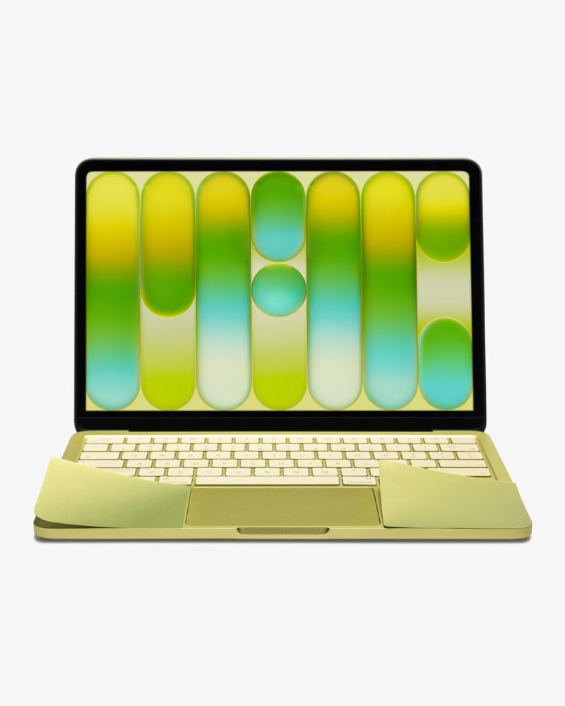 Front view of a Citrus MacBook Neo with GhostShield palm rest protector, lid open