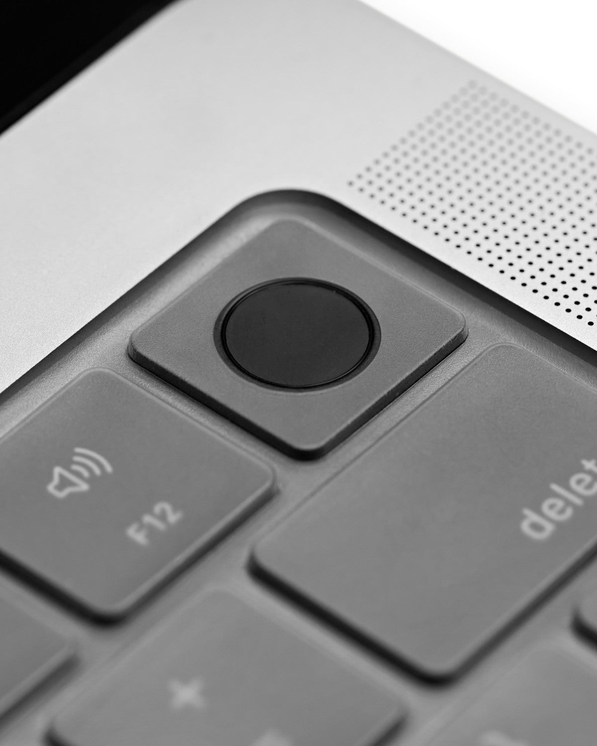 Close-up of a GhostCover keyboard protector over the Touch ID key of a MacBook