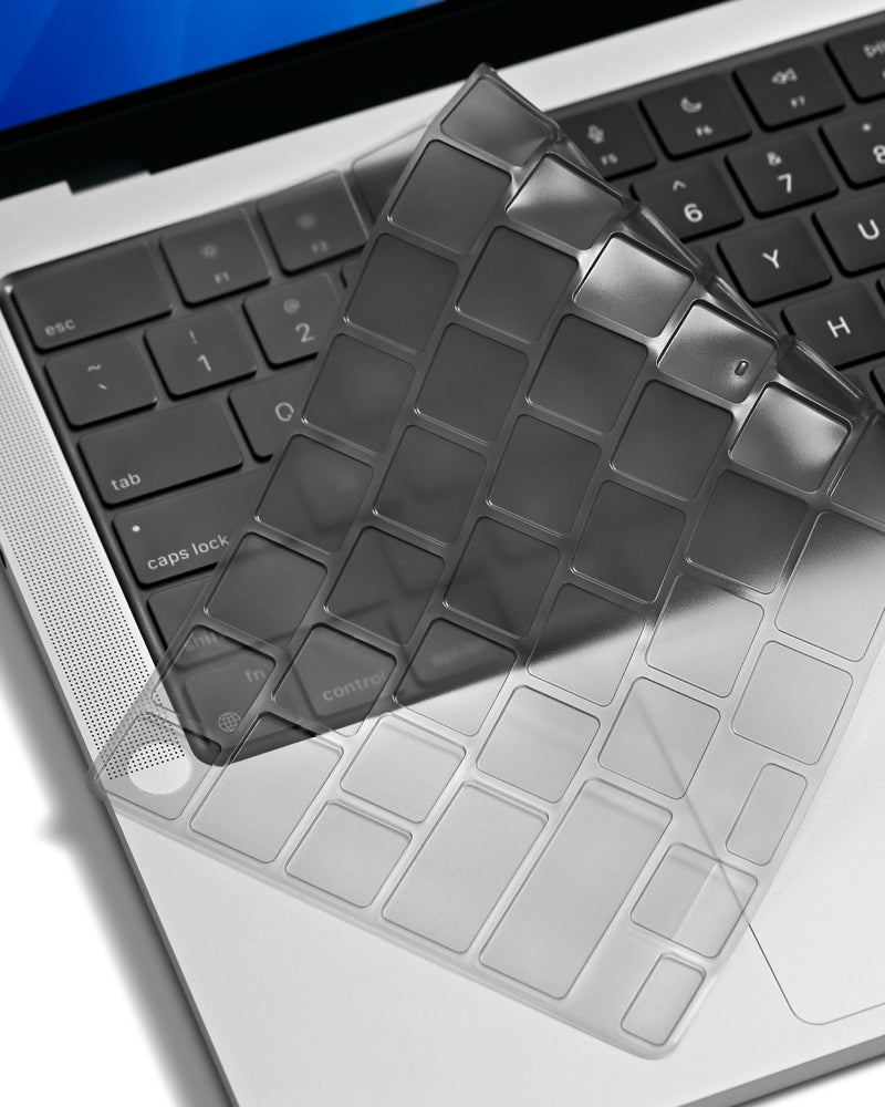 Tinted gray GhostCover keyboard protector lifting off a MacBook keyboard 