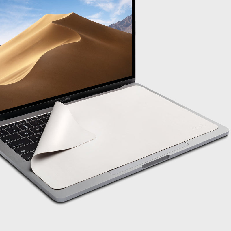 GhostBlanket microfiber liner draped over a MacBook keyboard with one corner folded back showing its thin profile